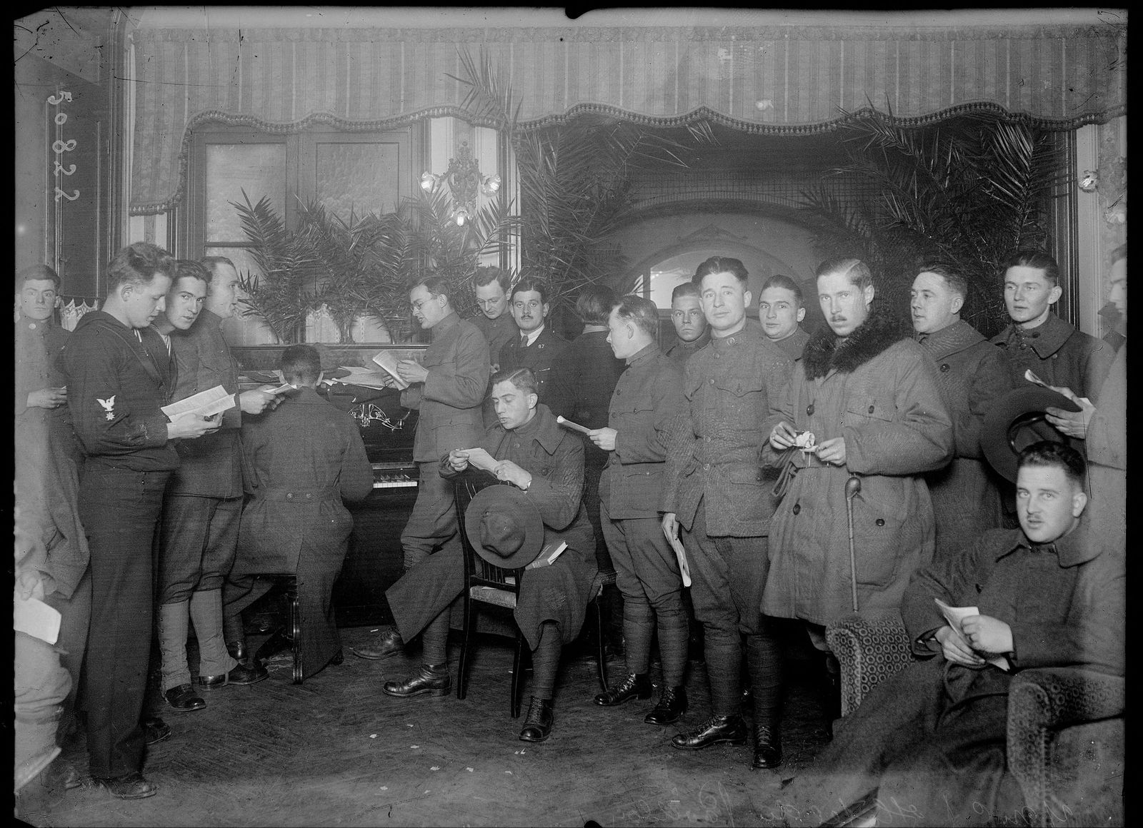 The lobby of the Grand Hôtel du Pavillon in Paris, with people seated reading.