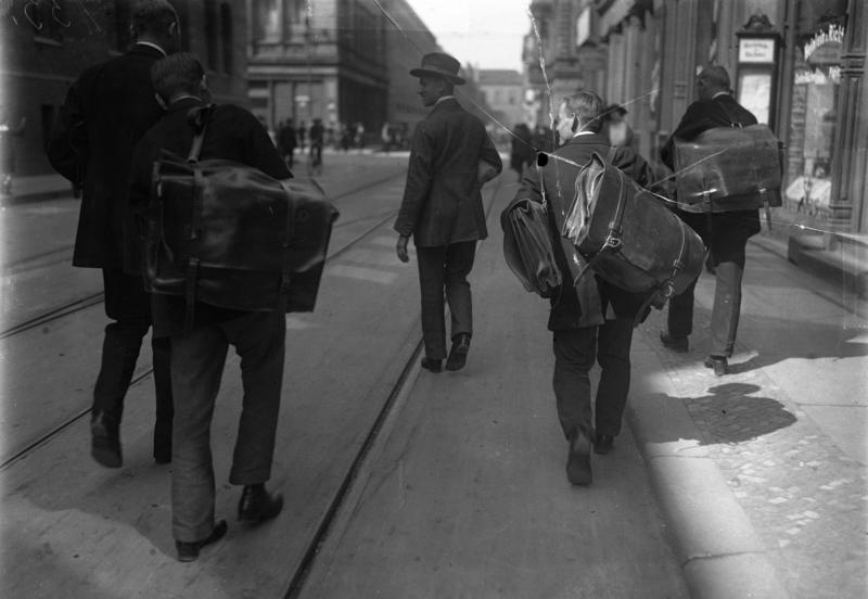 Reichsbank staff carrying bags of cash under police escort during Germany's 1923 currency collapse.